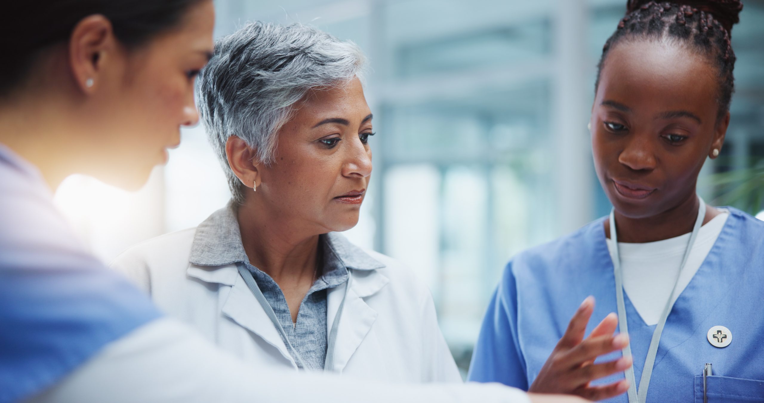 Female doctors discussing surgery notes