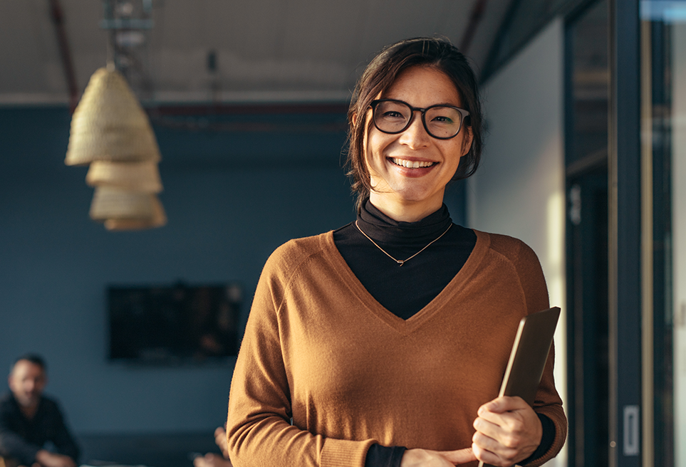 Portrait of a woman smiling holding a tablet