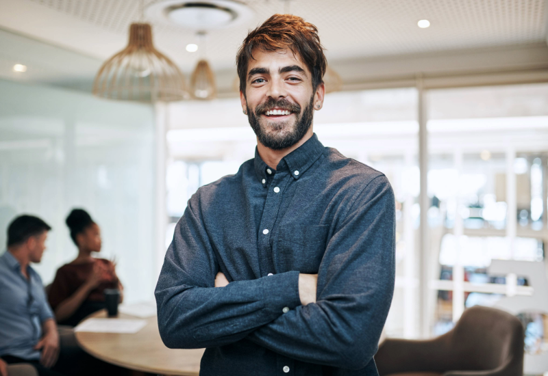 Wifi 7 man standing smiling with arms crossed